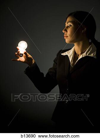 Profile of businesswoman with light bulb View Large Photo Image Stock Image - Profile of businesswoman with light bulb. Fotosearch