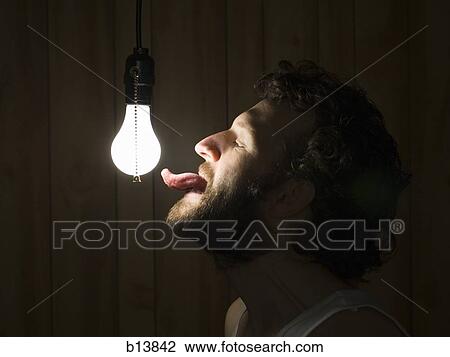 Profile of man with tongue out to light bulb View Large Photo Image Stock Image - Profile of man with tongue out to light bulb. Fotosearch