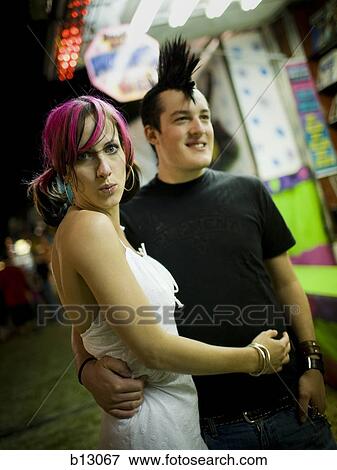 Stock Photo - Punk couple at a fairground. Fotosearch
