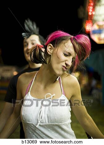 Stock Photo - Punk couple at a fairground. Fotosearch