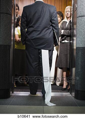 Rear view of a businessman entering an elevator View Large Photo Image Stock Image - Rear view of a businessman entering an elevator. Fotosearch