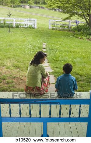 Stock Image - Rear view of a woman looking at her son. Fotosearch