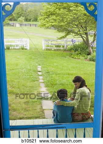 Stock Image - Rear view of a woman looking at her son. Fotosearch