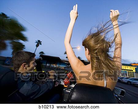 Rear view of a young couple sitting in a car View Large Photo Image Stock Image - Rear view of a young couple sitting in a car. Fotosearch