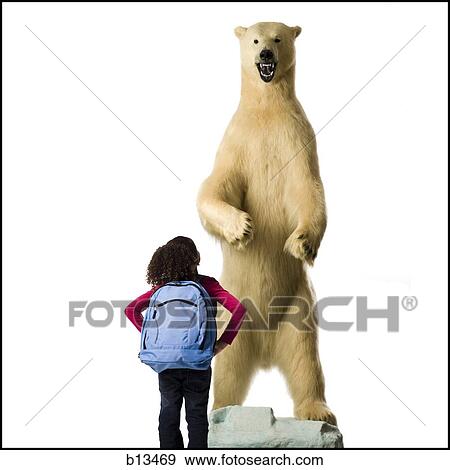 Stock Photo - Rear view of girl with polar bear. Fotosearch
