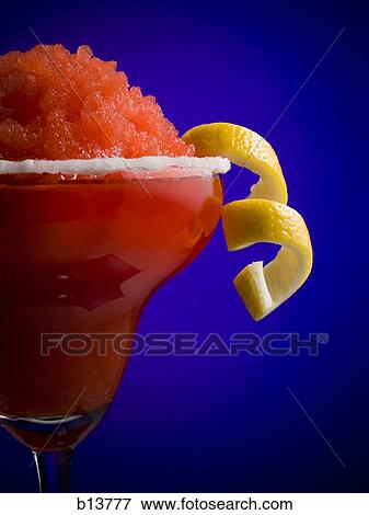 Red slush beverage in cocktail glass with lemon garnish View Large Photo Image Stock Photo - Red slush beverage in cocktail glass with lemon garnish. Fotosearch