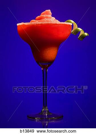 Stock Photo - Red slush beverage in cocktail glass with lime garnish. Fotosearch