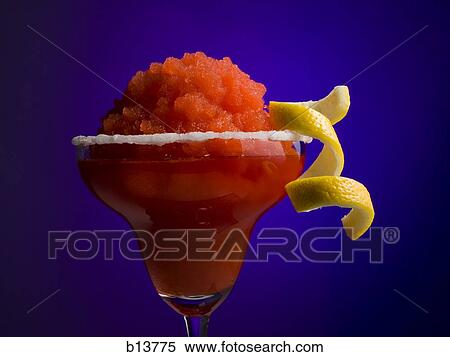 Stock Photography - Red slush beverage in cocktail glass with lemon garnish. Fotosearch