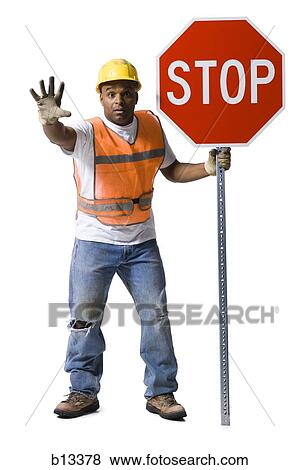 Stock Photo - Road worker with stop sign and hardhat. Fotosearch