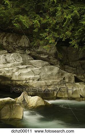 Rock formation with trees and water View Large Photo Image Stock Image - Rock formation with trees and water. Fotosearch