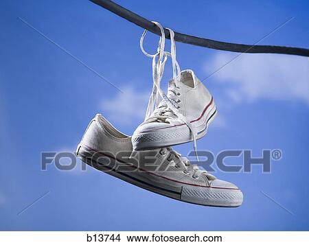 Running shoes hanging on wire outdoors with blue sky Picture | b13744 ...