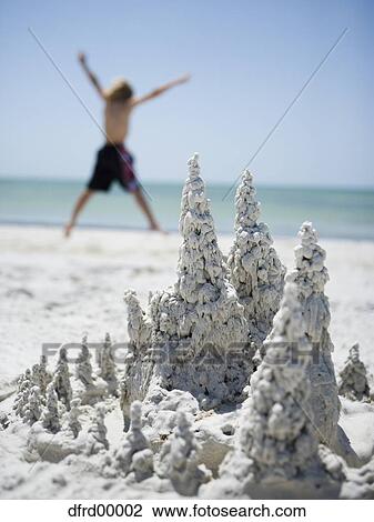 Sand formation at beach with child leaping View Large Photo Image Stock Image - Sand formation at beach with child leaping. Fotosearch