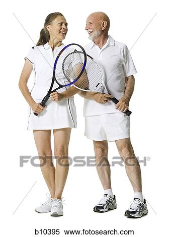 Senior couple standing with tennis rackets View Large Photo Image Stock Photography - Senior couple standing with tennis rackets. Fotosearch