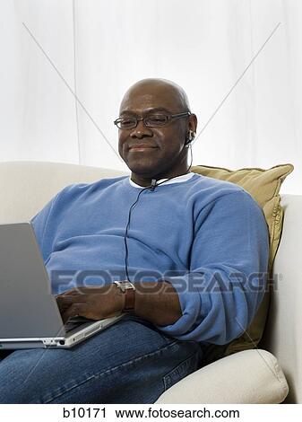 Stock Image - Senior man using a laptop. Fotosearch