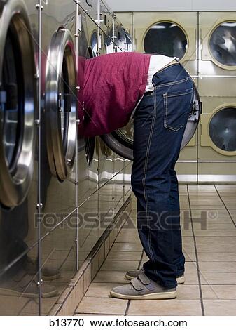 Side profile of man with head and arms in dryer at Laundromat View Large Photo Image Stock Image - Side profile of man with head and arms in dryer at Laundromat. Fotosearch