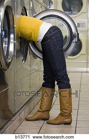 Side profile of woman with head and arms in dryer at Laundromat View Large Photo Image Stock Image - Side profile of woman with head and arms in dryer at Laundromat. Fotosearch