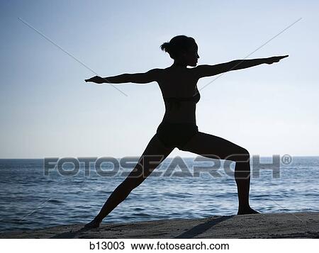Silhouette of a woman exercising on a beach View Large Photo Image Stock Image - Silhouette of a woman exercising on a beach. Fotosearch