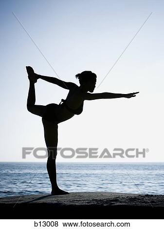 Silhouette of a woman exercising on a beach View Large Photo Image Stock Photo - Silhouette of a woman exercising on a beach. Fotosearch