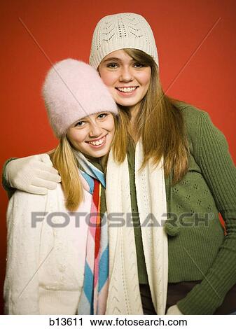 Sisters embracing with hats and scarves View Large Photo Image Stock Image - Sisters embracing with hats and scarves. Fotosearch