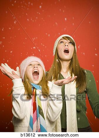 Sisters looking up at snow View Large Photo Image Stock Image - Sisters looking up at snow. Fotosearch