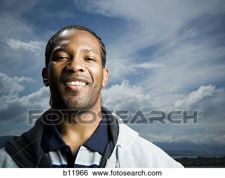 Stock Photograph - Smiling man outdoors. Fotosearch