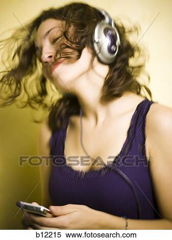 Smiling teenage girl listening to MP3 player View Large Photo Image Stock Photography - Smiling teenage girl listening to MP3 player. Fotosearch