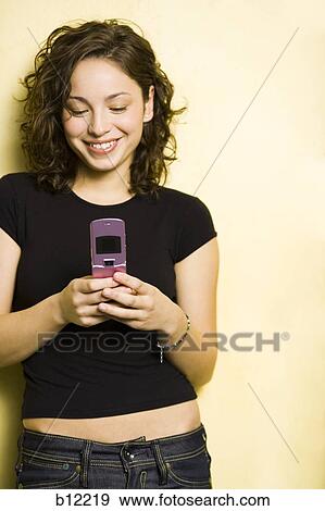 Smiling teenage girl with cell phone View Large Photo Image Stock Photo - Smiling teenage girl with cell phone. Fotosearch