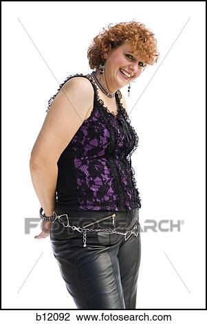Smiling woman with red hair in leather pants View Large Photo Image Stock Image - Smiling woman with red hair in leather pants. Fotosearch