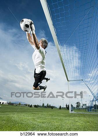 Soccer goalkeeper making diving save View Large Photo Image Picture - Soccer goalkeeper making diving save. Fotosearch