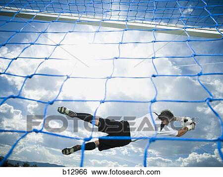 Stock Photograph - Soccer goalkeeper making diving save. Fotosearch