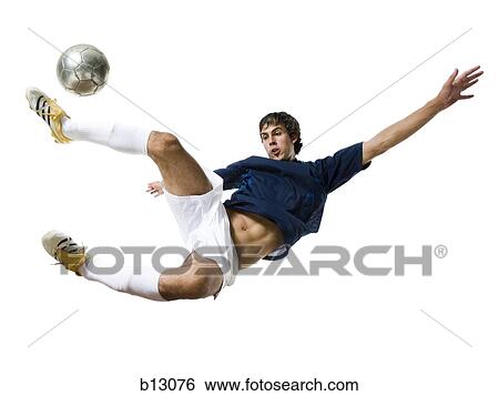 Stock Photograph - Soccer player kicking ball. Fotosearch