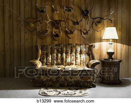 Sofa with lamp and antlers View Large Photo Image Stock Photo - Sofa with lamp and antlers. Fotosearch