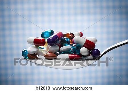 Spoonful of pills and capsules View Large Photo Image Stock Photo - Spoonful of pills and capsules. Fotosearch