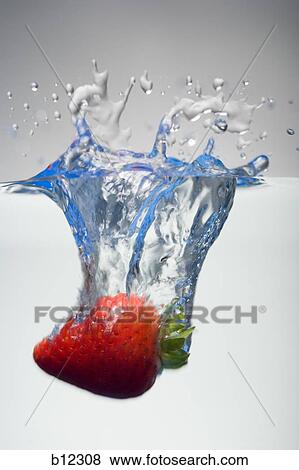 Stock Photo - Strawberry being dropped into water. Fotosearch