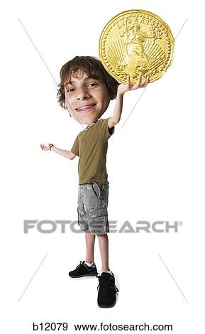 Teenage boy holding a US gold coin View Large Photo Image Stock Photo - Teenage boy holding a US gold coin. Fotosearch