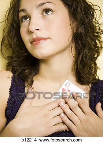 Picture - Teenage girl holding cart to chest. Fotosearch