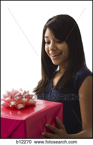 Stock Image - Teenage girl with gift. Fotosearch
