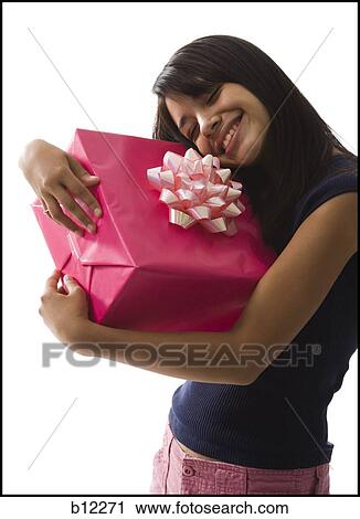 Stock Image - Teenage girl with gift. Fotosearch