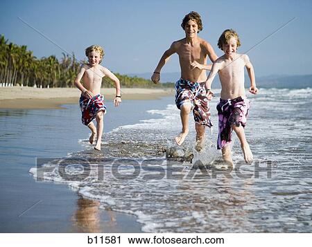 Three boys playing on beach View Large Photo Image Stock Image - Three boys playing on beach. Fotosearch