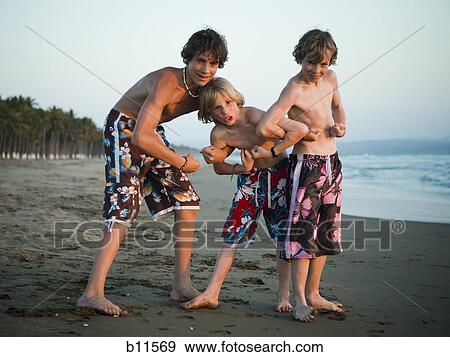 Three boys playing on beach View Large Photo Image Stock Photo - Three boys playing on beach. Fotosearch