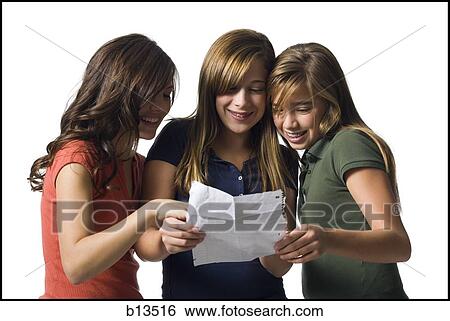 Three girls reading a letter smiling View Large Photo Image Stock Photograph - Three girls reading a letter smiling. Fotosearch