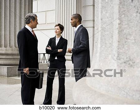Three lawyers talking in front of a courthouse View Large Photo Image Stock Image - Three lawyers talking in front of a courthouse. Fotosearch