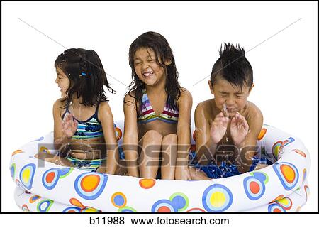 Stock Photo - Three young girls playing in inflatable pool. Fotosearch