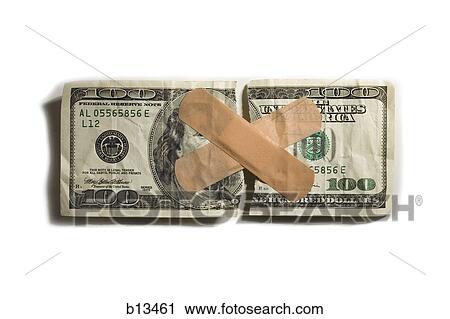 Stock Image - Torn US one hundred dollar bill with bandages. Fotosearch