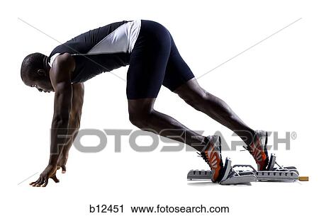 Stock Image - Track runner in starting position ready to race. Fotosearch