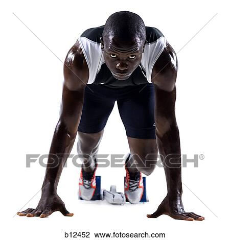 Stock Image - Track runner in starting position ready to race. Fotosearch