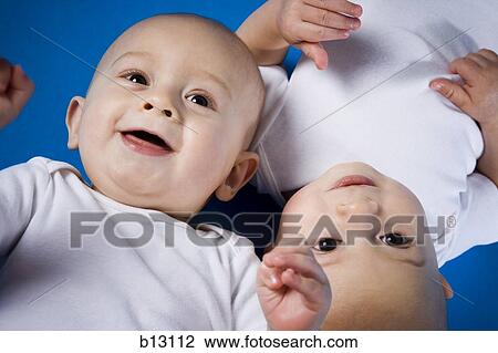 Twin babies looking up View Large Photo Image Stock Image - Twin babies looking up. Fotosearch
