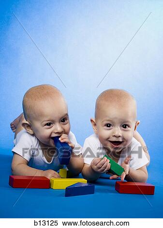 Twin babies on bellies with blocks View Large Photo Image Stock Photography - Twin babies on bellies with blocks. Fotosearch