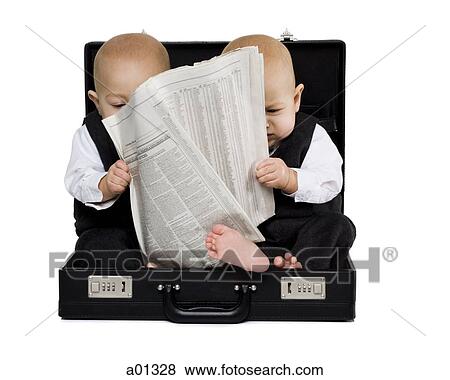 Twin boys sitting in a briefcase with newspaper View Large Photo Image Stock Photo - Twin boys sitting in a briefcase with newspaper. Fotosearch