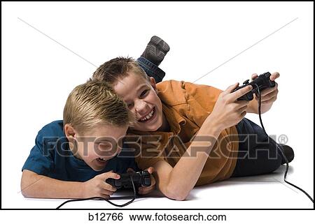Two brothers playing a video game View Large Photo Image Stock Photograph - Two brothers playing a video game. Fotosearch